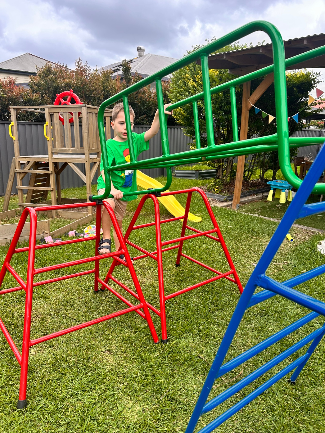 Boy climbing on outdoor play equipment