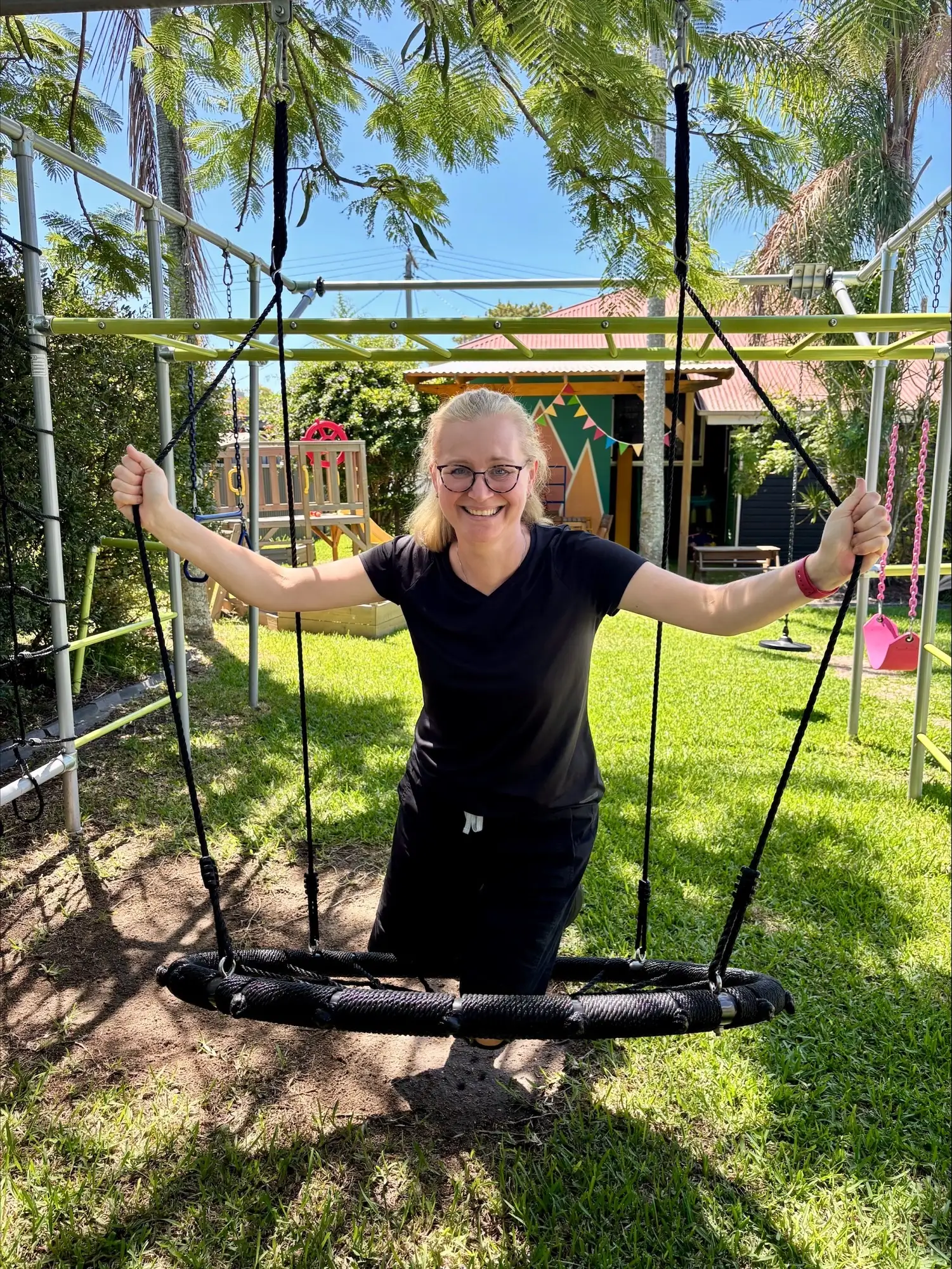 Therapist on a nest swing in the playground
